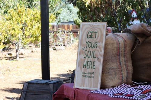 "Get your soil here" sign at soil pickup table